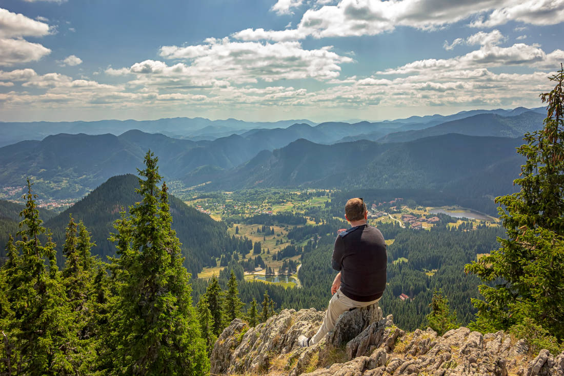 A man enjoys a beautiful view from top .Travel in the mountains.
